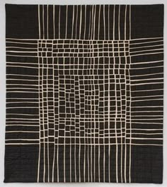 a black and white quilt with lines on it