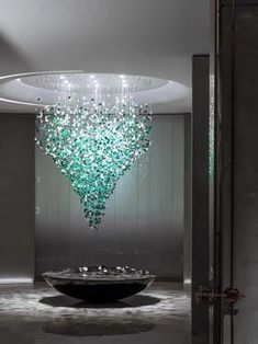 a large glass chandelier hanging from the ceiling in a room with white walls