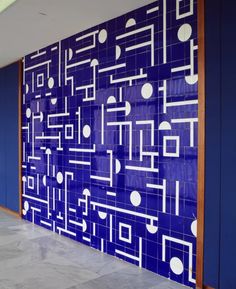 a blue wall with white circles and lines painted on it in an office building lobby