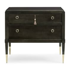 a black dresser with two drawers and brass legs