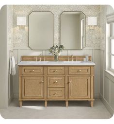 a bathroom vanity with two mirrors above it