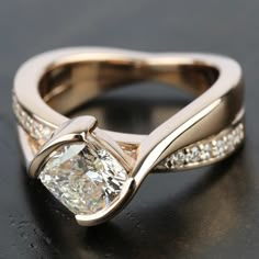 a close up view of a gold ring with diamonds on it and the center stone in the middle