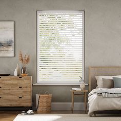 a bedroom with a bed, dresser and window covered in blinds