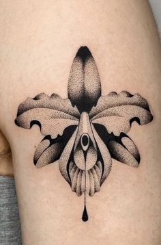 a woman's thigh with a tattoo design on it