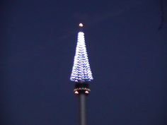 the eiffel tower is lit up in blue and white lights at night time