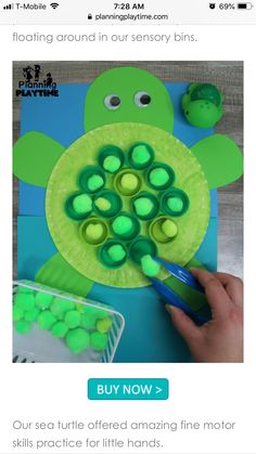 an image of a turtle made out of plastic bottle caps and some green buttons on it