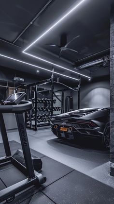 a black sports car is parked in a gym with treadmills and exercise equipment