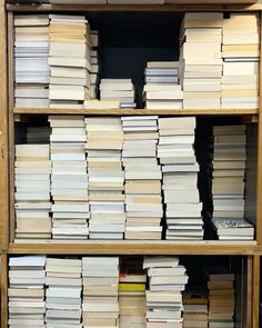 stacks of books are stacked on top of each other in a bookcase at the library