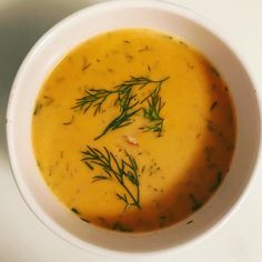 a white bowl filled with soup on top of a table