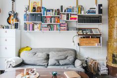 a living room filled with furniture and bookshelves full of different types of books