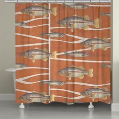 a shower curtain with fish on an orange background