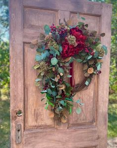 a wooden door with a wreath on it