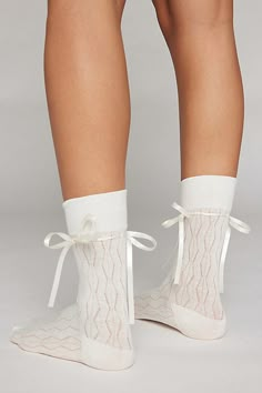 Oh-so-soft crew socks in a lightweight open knit. Tall crew sock style laced with a tonal satin ribbon tied with a bow for a sweet statement socks look. Features Ariana bow crew socks Seriously soft crew socks Tonal satin ribbon accent Bow detail Lightweight cotton blend Crew length Content + Care 80% Cotton, 15% polyester, 5% spandex Machine wash Imported Size Crew sock length Fits US women’s shoe size 6–10 | Ariana Bow Crew Sock in White, Women's at Urban Outfitters Cute Socks Aesthetic, Girly Socks, Sabrina Carpenter Concert, Bow Socks, Cute Loungewear, Statement Socks, Pretty Socks, Socks Aesthetic, Cute Lounge