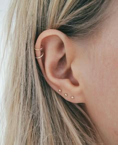 a close up of a person wearing an ear piercing