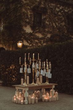 a table topped with lots of candles next to a building