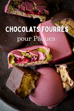 chocolates with raspberries and other toppings are on a plate that says, chocolats fourres pour paques