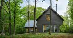 a house in the woods surrounded by trees