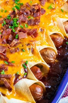 a casserole dish with bacon, cheese and other toppings on it's side