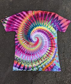 a colorful tie - dyed t - shirt laying on the ground