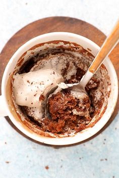 a spoon is in a bowl with some food