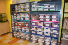 the shelves are filled with various containers and bins for storing items or other things