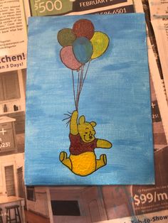 a painting of winnie the pooh flying with balloons on top of newspaper pages,