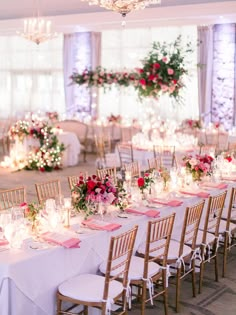 the tables are set up with white linens and pink napkins for an elegant wedding reception