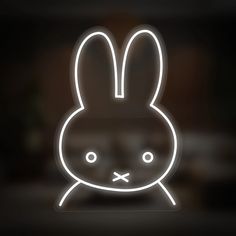 a neon sign with a rabbit face on it's head and eyes glowing in the dark