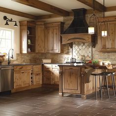 a kitchen with wooden cabinets and tile flooring