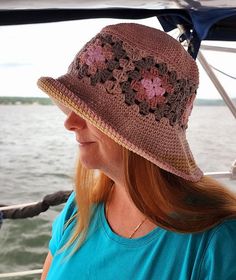 A crochet granny square bucket hat worn by a woman.