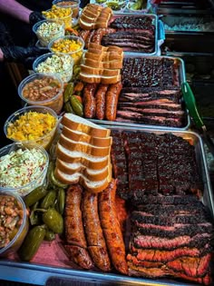 many different types of meats and other foods are on display at a buffet table