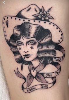 a woman's thigh with an old school tattoo on it