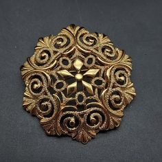 This vintage Monet brooch features a gold tone filigree design and measures 2" D It is signed Monet on the back of the brooch Victorian Gold Brooches With Intricate Design, Gold Victorian Brooches With Intricate Design, Antique Gold Brooch With Intricate Design, Victorian Gold Brooch With Intricate Design, Antique Gold Brooches With Intricate Design, Gold Victorian Brooch With Intricate Design, Gold Filigree Ornate Brooches, Ornate Gold Filigree Brooches, Ornate Gold Brooch With Intricate Design