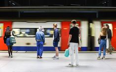 several people waiting for the subway to arrive