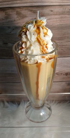 an ice cream sundae with caramel drizzle and whipped cream