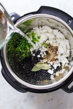 the ingredients are being mixed in an instant pot with water to make it look like they have been cooked