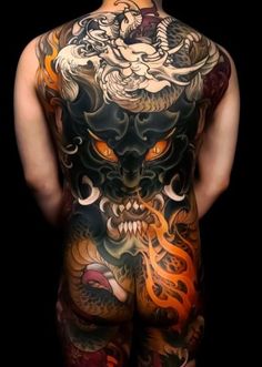 the back of a man with tattoos on his body