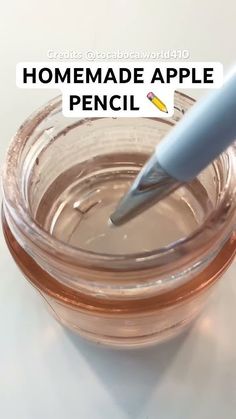 a glass jar filled with brown liquid and a blue marker on the lid that says homemade apple pencil