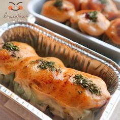 two tin pans filled with food on top of a table