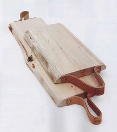 an old wooden sled sitting on top of a white surface