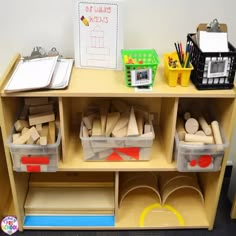 a wooden shelf filled with lots of different types of crafting supplies on top of it