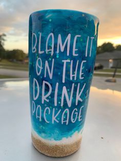 a blue cup with white writing on it that says,'blame it on the drink package '