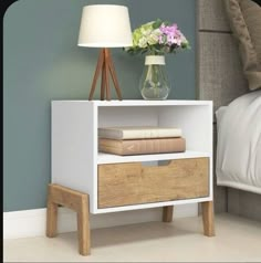 a nightstand with two drawers and a lamp next to it