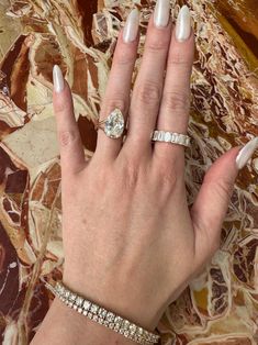 a woman's hand with two rings on it