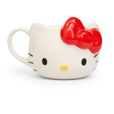 a hello kitty mug with a red bow on it