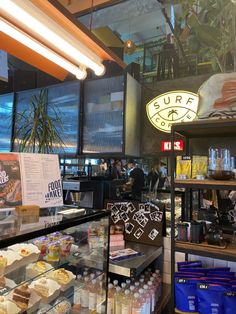 the inside of a deli filled with lots of food and drink bottles on display