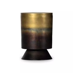 a black and gold vase sitting on top of a table