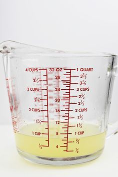 a measuring cup filled with liquid on top of a table