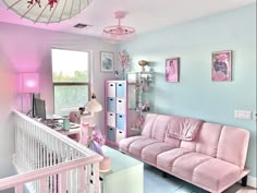 a living room with pink furniture and blue walls