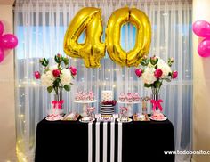 a table topped with cake and balloons in the shape of the number forty fifty two